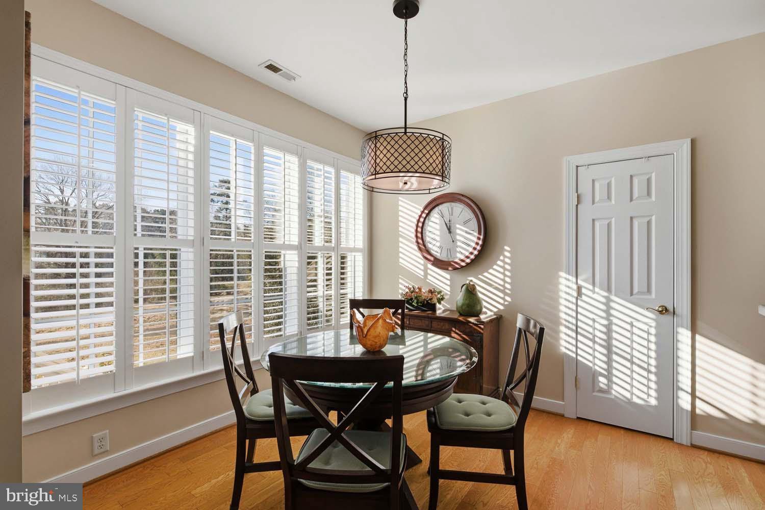 464 Middle Gate Irvington, VA 22480 - Photo 13 of 46 a view of a dining room with furniture window and wooden floor