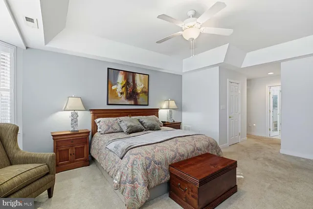 a spacious bedroom with a bed and a couch