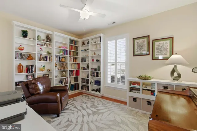 a living room with furniture cabinets and window