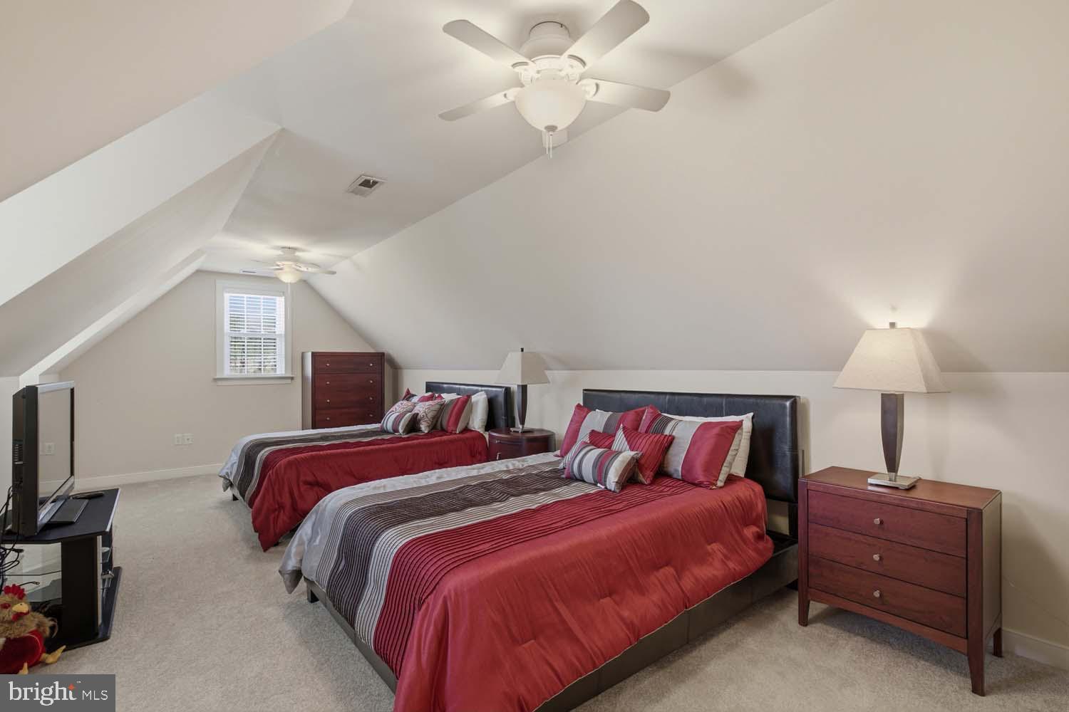 464 Middle Gate Irvington, VA 22480 - Photo 31 of 46 a bedroom with a bed and a chandelier