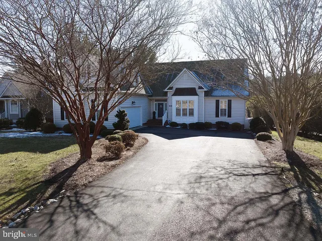 a view of a house with a yard covered in snow