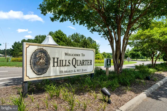 a sign of golf club on a tree