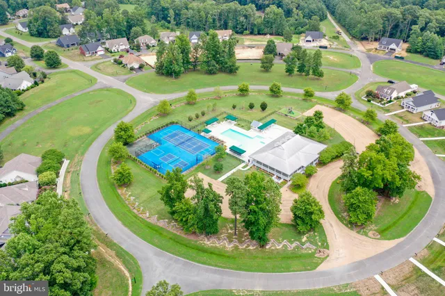 an aerial view of a house with outdoor space swimming pool