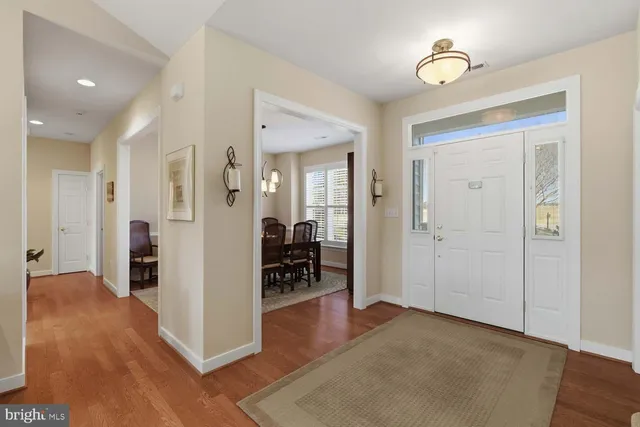 wooden floor in a hall with an entryway in a room