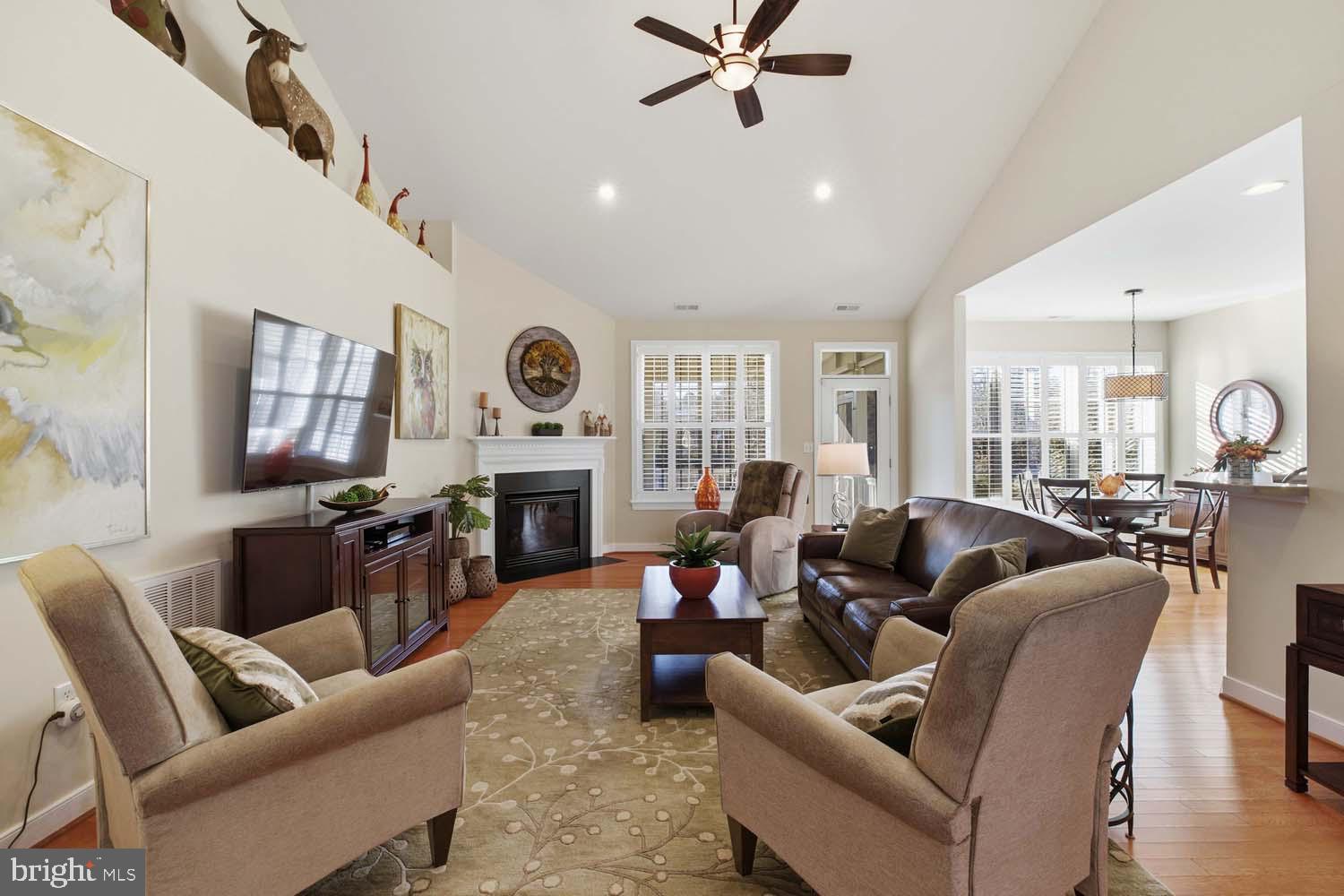 464 Middle Gate Irvington, VA 22480 - Photo 8 of 46 a living room with furniture a fireplace and a chandelier