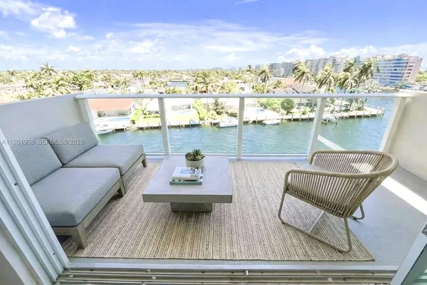 a view of a balcony with wooden floor and outdoor seating