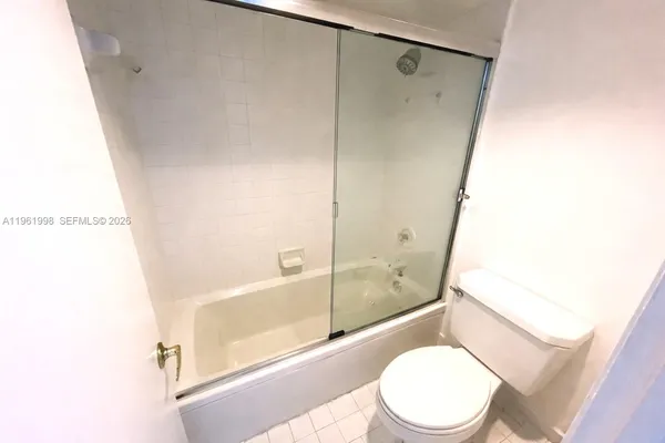 a white toilet sitting next to a bath tub