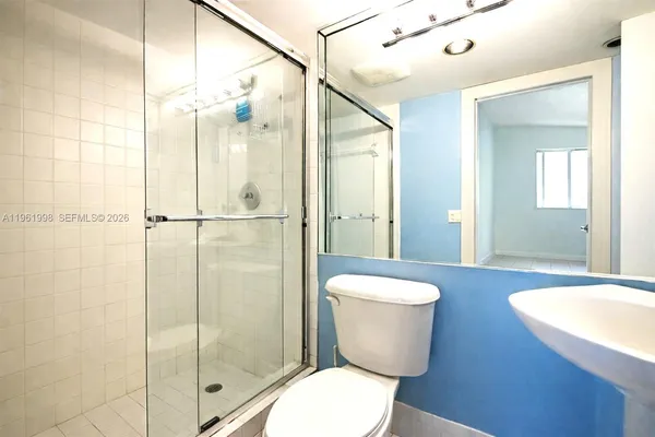 a bathroom with a toilet a sink and a shower