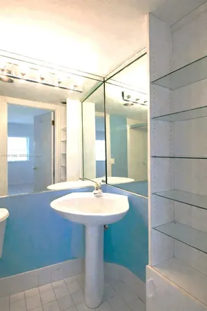 a bathroom with a sink and mirror