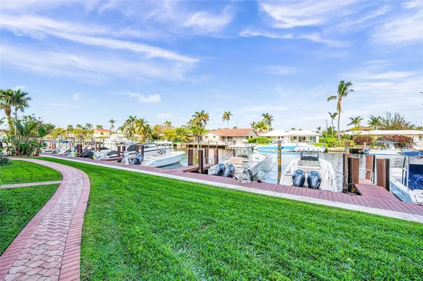 a view of a town with big yard and large trees