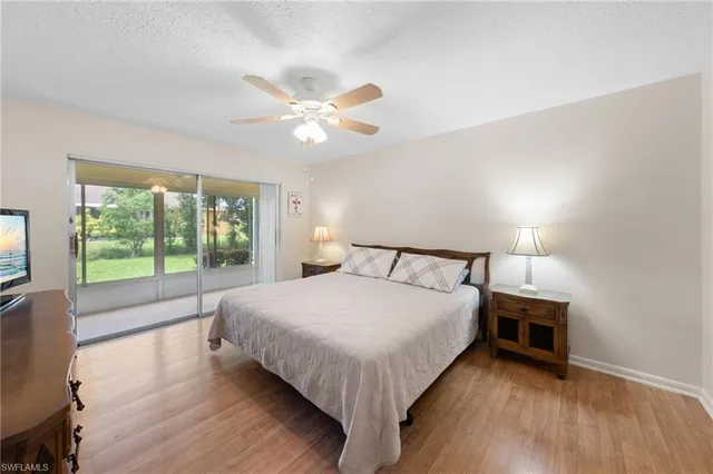 a large bed sitting in a bedroom next to a window