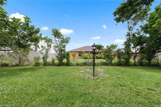 a view of a house with a backyard