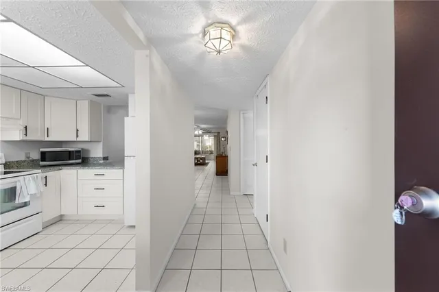 a view of a kitchen with white cabinets