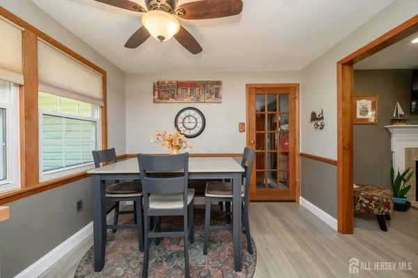 a view of a dining room with furniture and a large window