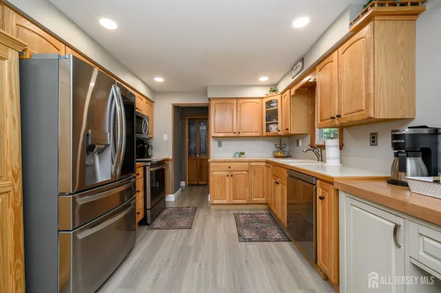 a kitchen with stainless steel appliances a refrigerator sink and microwave