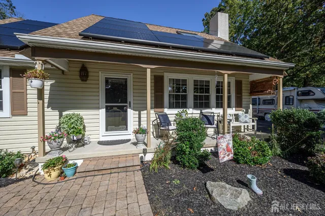 a front view of a house with potted plants