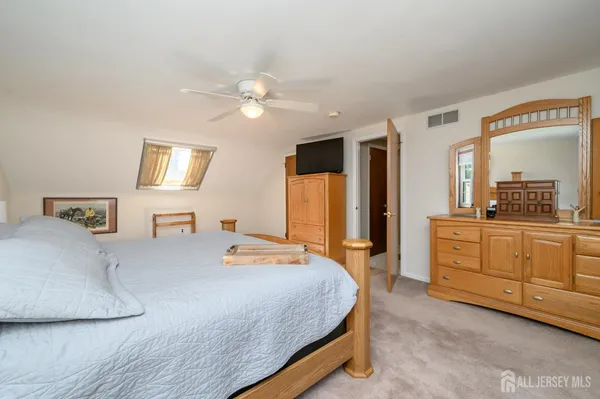 a bedroom with a large bed and dresser