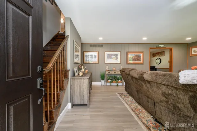 a living room with furniture and stairs