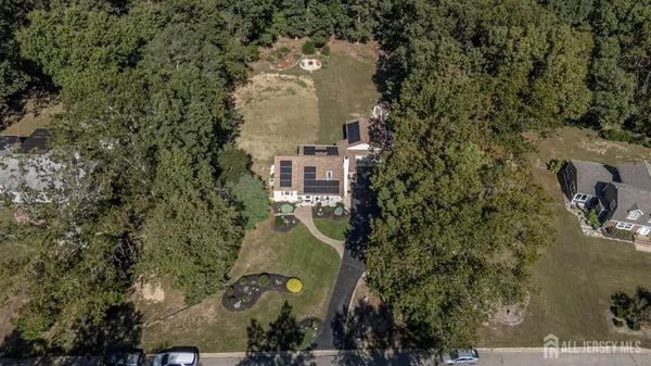 an aerial view of a house with outdoor space