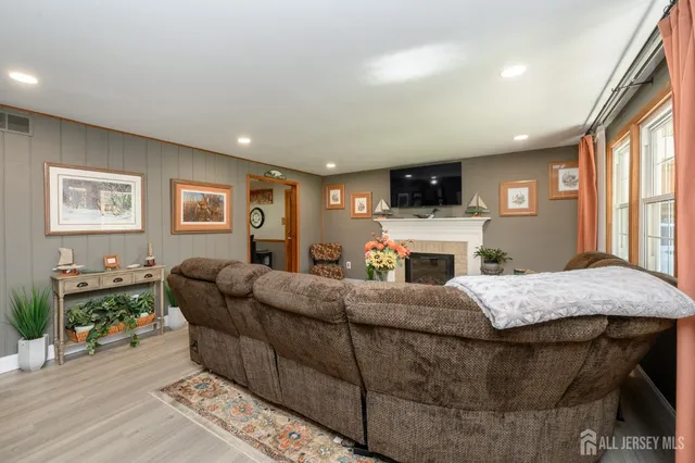 a living room with furniture a fireplace and a flat screen tv