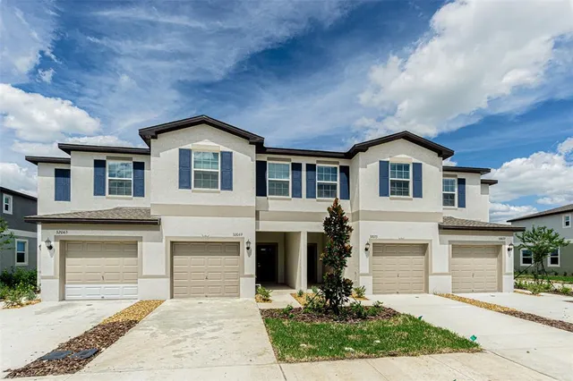 a front view of a house with yard