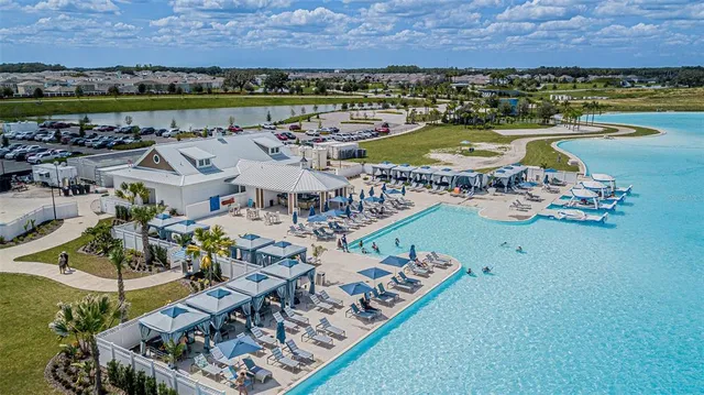 a front view of house with yard and trees in the background