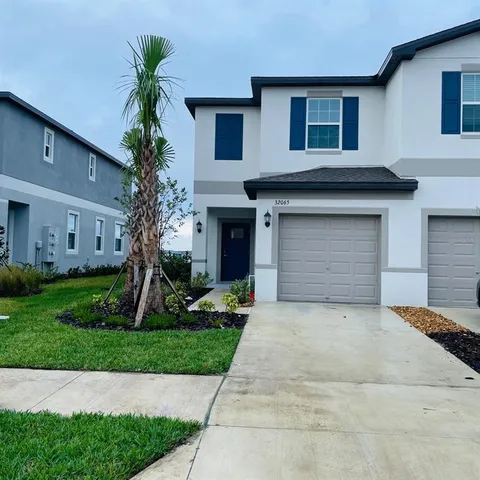 a front view of house with yard and green space