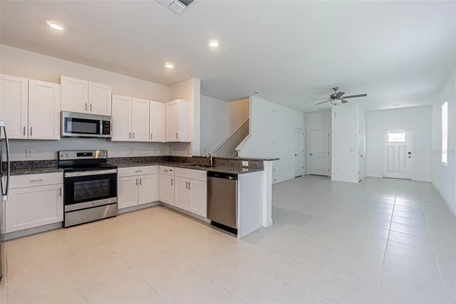 a kitchen that has a sink and stainless steel appliances