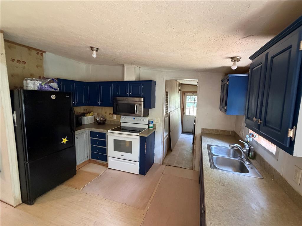 4541 Main Street Slatington, PA 18080 - Photo 24 of 27 Functional kitchen with dark cabinetry and ample counter space, ready for your culinary creations.