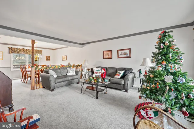 a living room with furniture and flowers