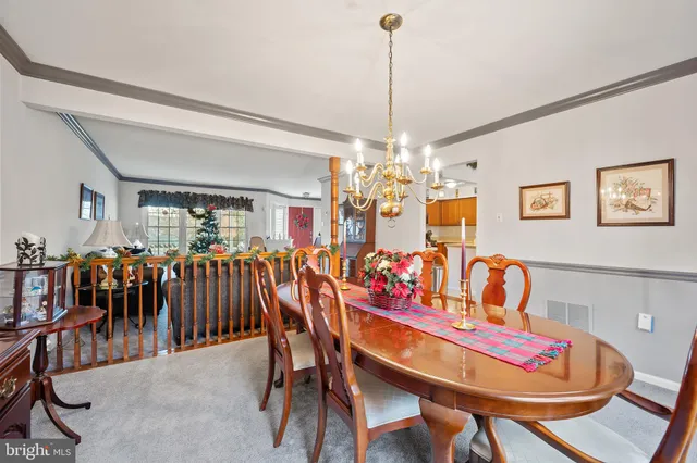 a view of a dining room with furniture and chandelier