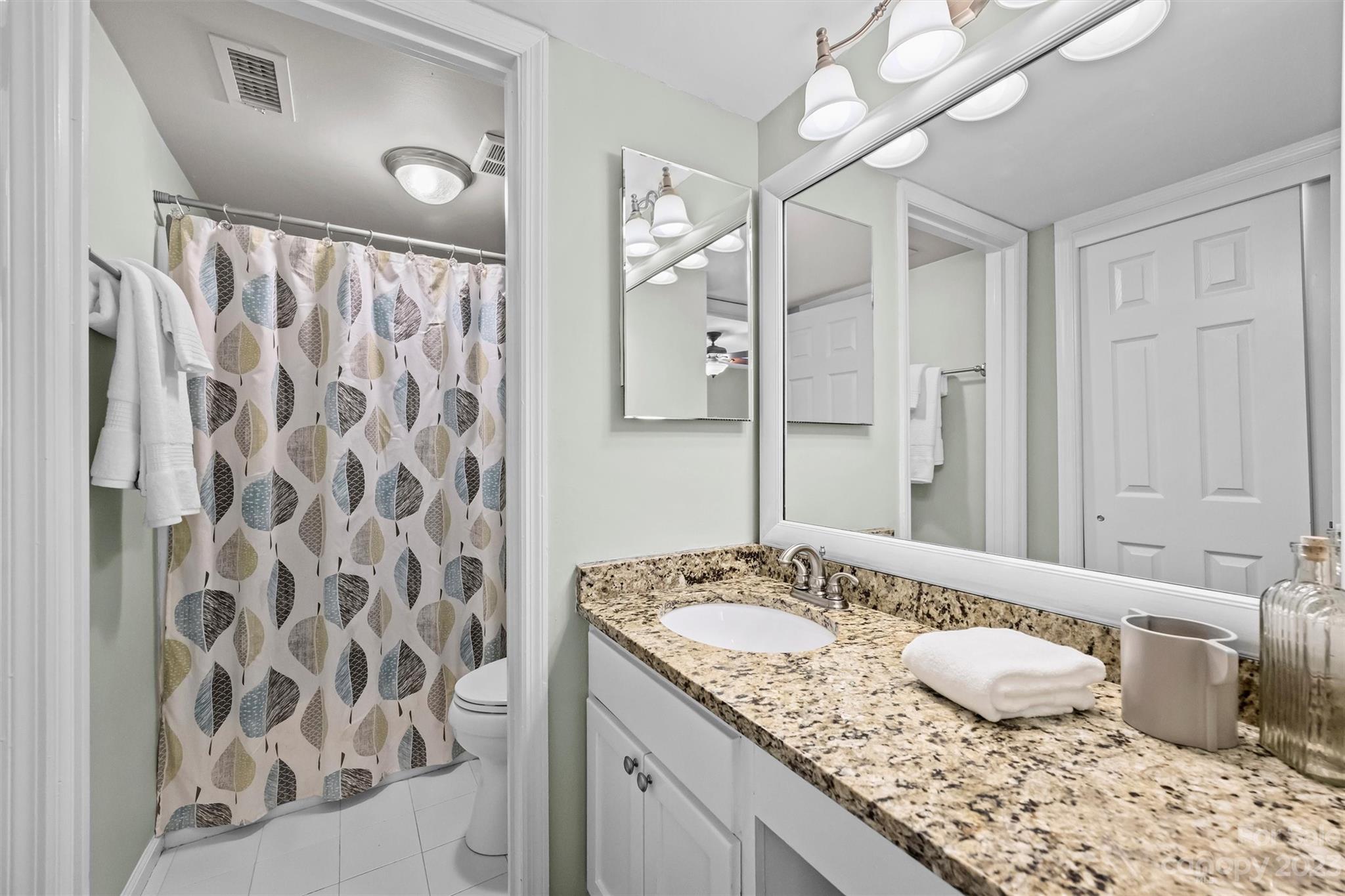 1712 Roxborough Road Charlotte, NC 28211 - Photo 29 of 44 a bathroom with a granite countertop sink and a mirror
