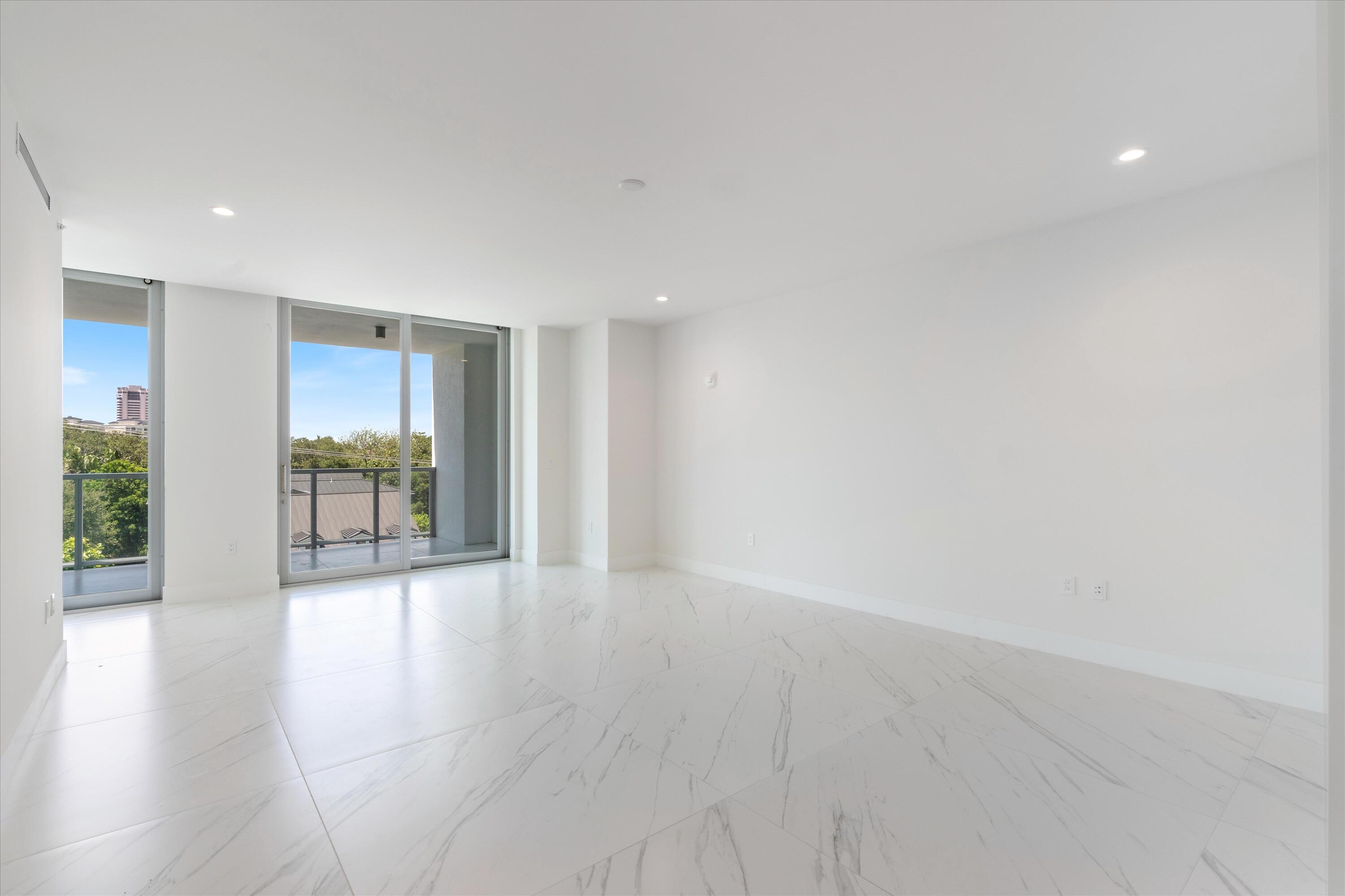 495 East Royal Palm Road, Unit 402 Boca Raton, FL 33432 - Photo 23 of 72 a view of an empty room with wooden floor and a fireplace