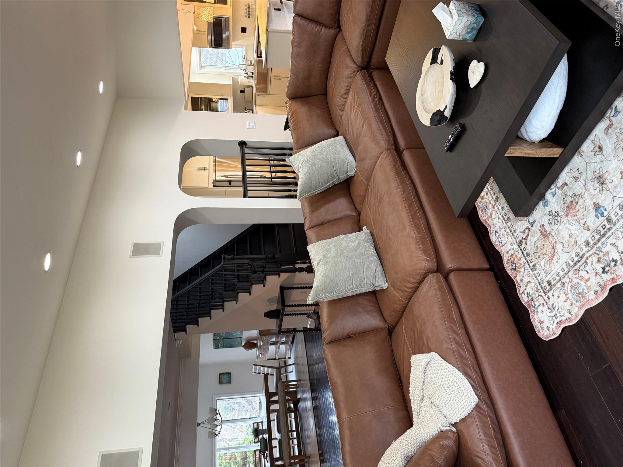 29 Wilton Road Rye Brook, NY 10573 - Photo 18 of 18 Living room featuring wood finished floors, plenty of natural light, recessed lighting, arched walkways, and stairs