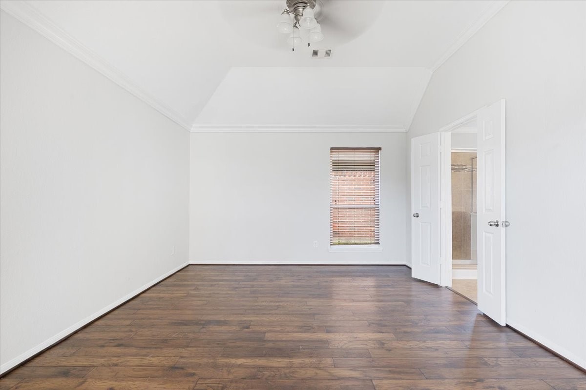 5446 Seabird Street Baytown, TX 77521 - Photo 11 of 23 The primary bedroom offers a comfortable and private retreat with direct access to the en-suite primary bath for added convenience.