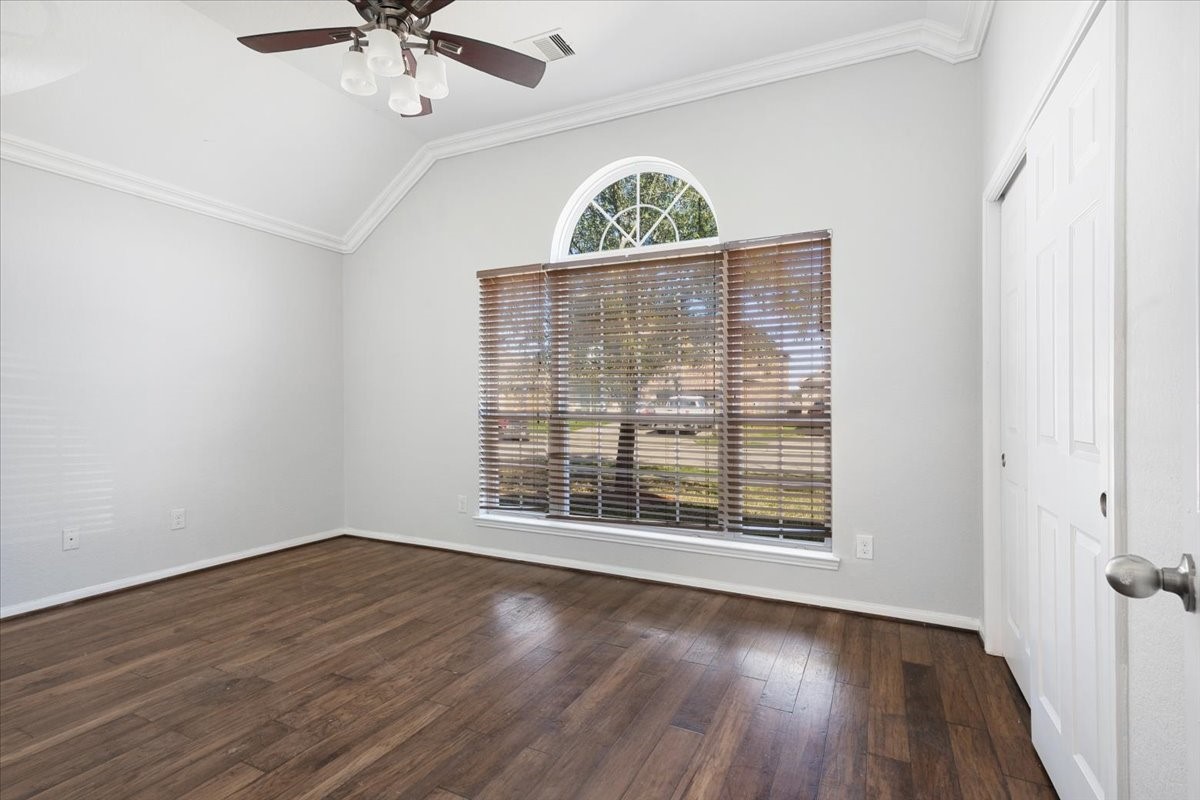 5446 Seabird Street Baytown, TX 77521 - Photo 14 of 23 Bedroom two features a large front-facing window that brings in abundant natural light and enhances the room’s airy feel.