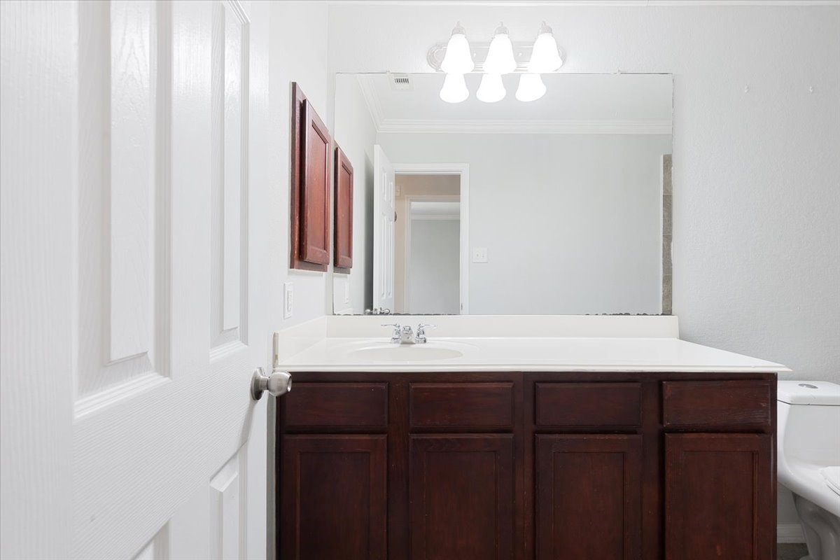 5446 Seabird Street Baytown, TX 77521 - Photo 15 of 23 The second bath features a large mirror and excellent lighting, creating a bright and functional space for everyday use.