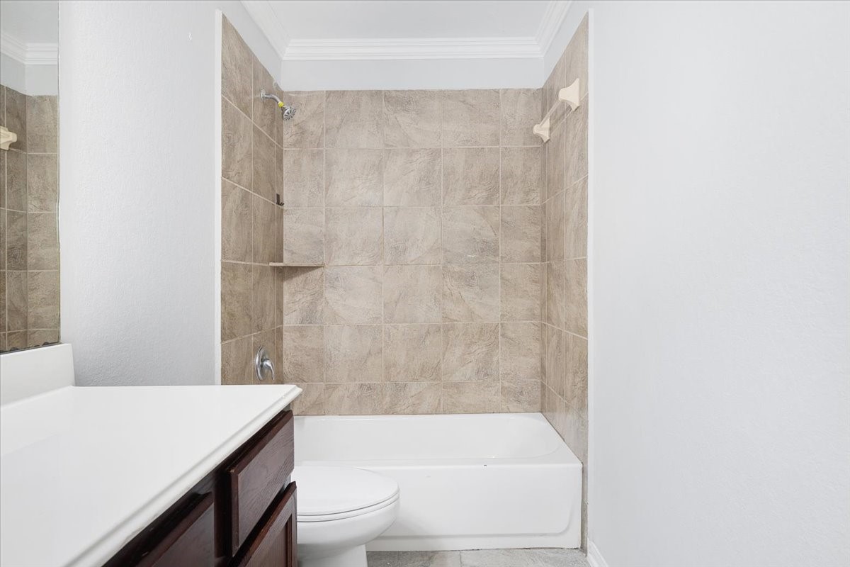 5446 Seabird Street Baytown, TX 77521 - Photo 16 of 23 The second bath includes a shower and tub combination.