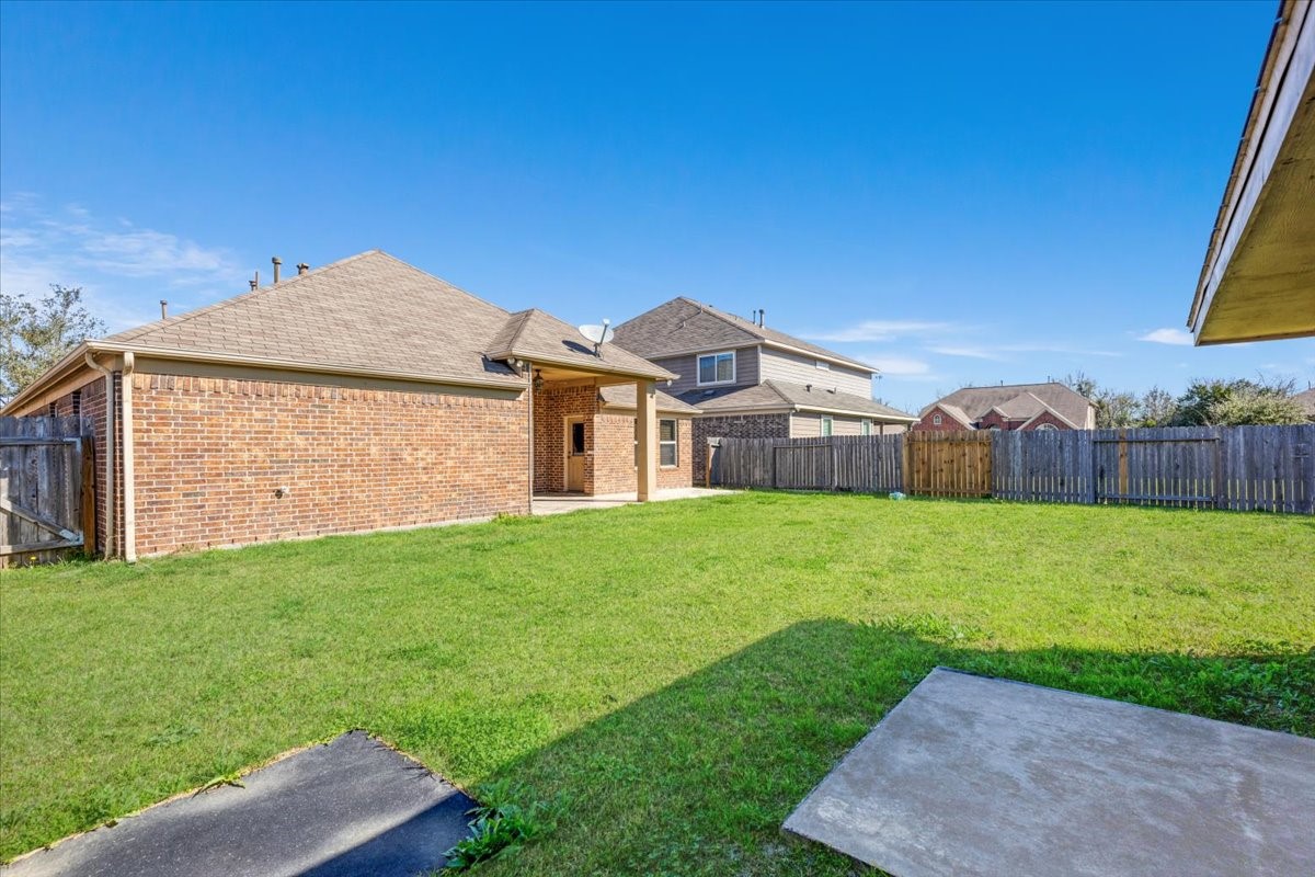 5446 Seabird Street Baytown, TX 77521 - Photo 21 of 23 The backyard boasts abundant greenery and ample open space, ideal for outdoor activities, gardening, or simply enjoying nature.