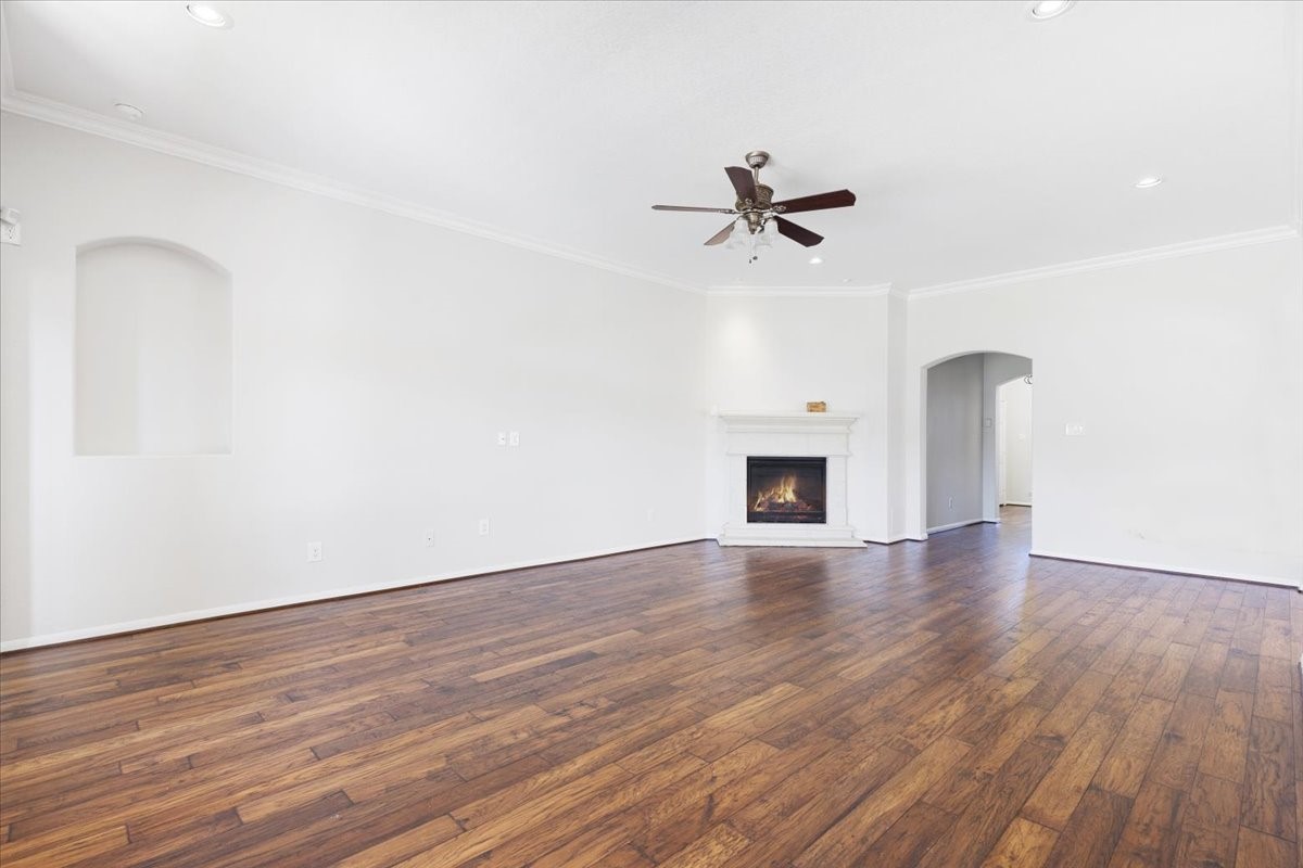 5446 Seabird Street Baytown, TX 77521 - Photo 5 of 23 Another view of the living room highlights the cozy chimney, creating a warm and inviting focal point for the space.