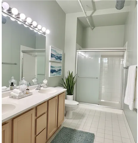a bathroom with a double vanity sink and a mirror
