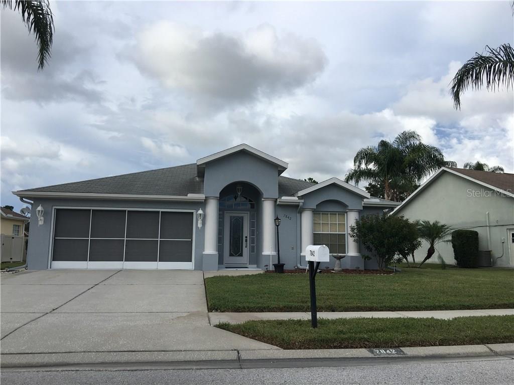 7842 Starfire Way New Port Richey, FL 34654 - Photo 1 of 1 a front view of a house with a yard