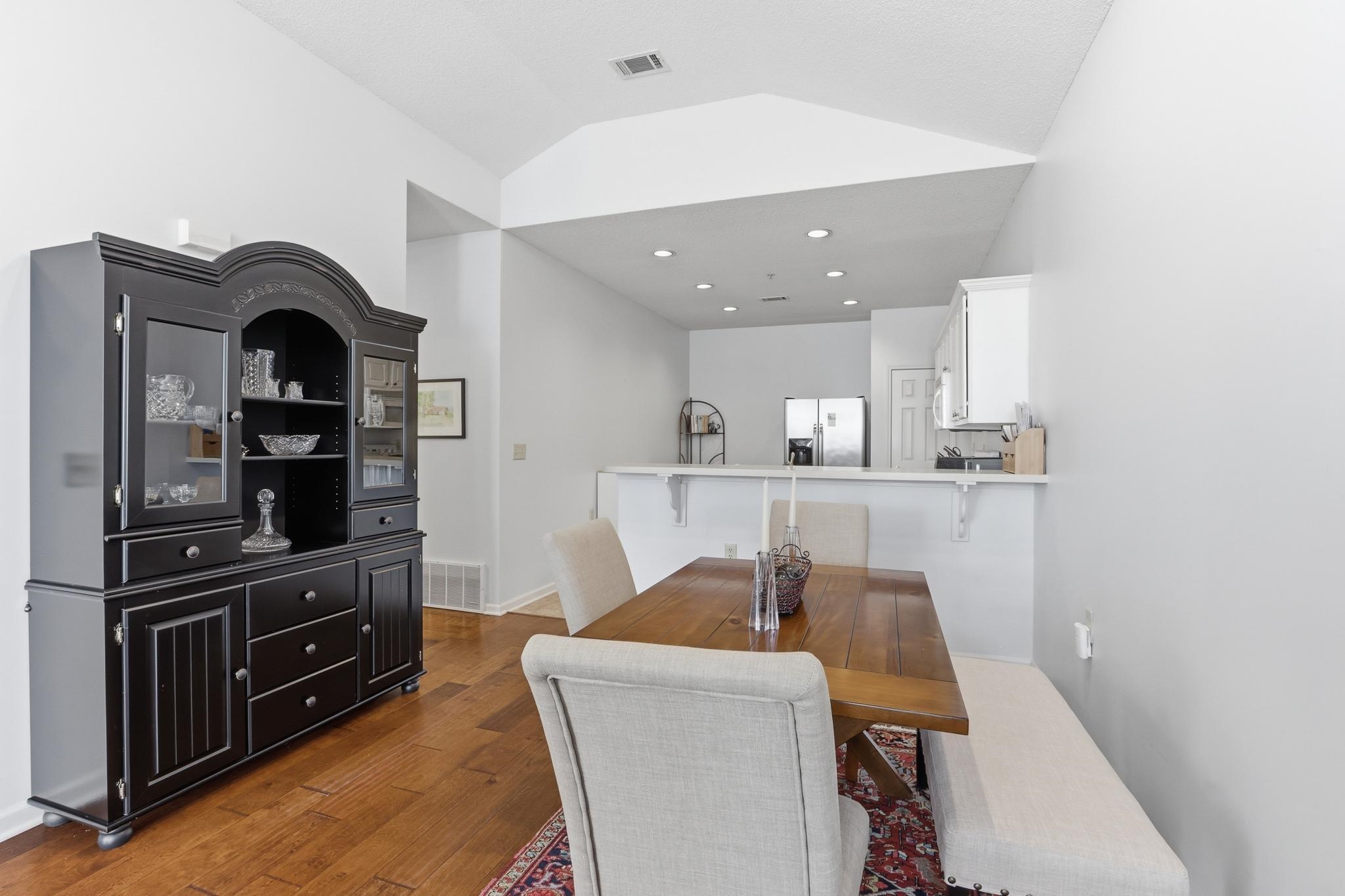 1075 Oak Timber Circle, Unit 69 Collierville, TN 38017 - Photo 16 of 35 a kitchen with a dining table cabinets and stainless steel appliances