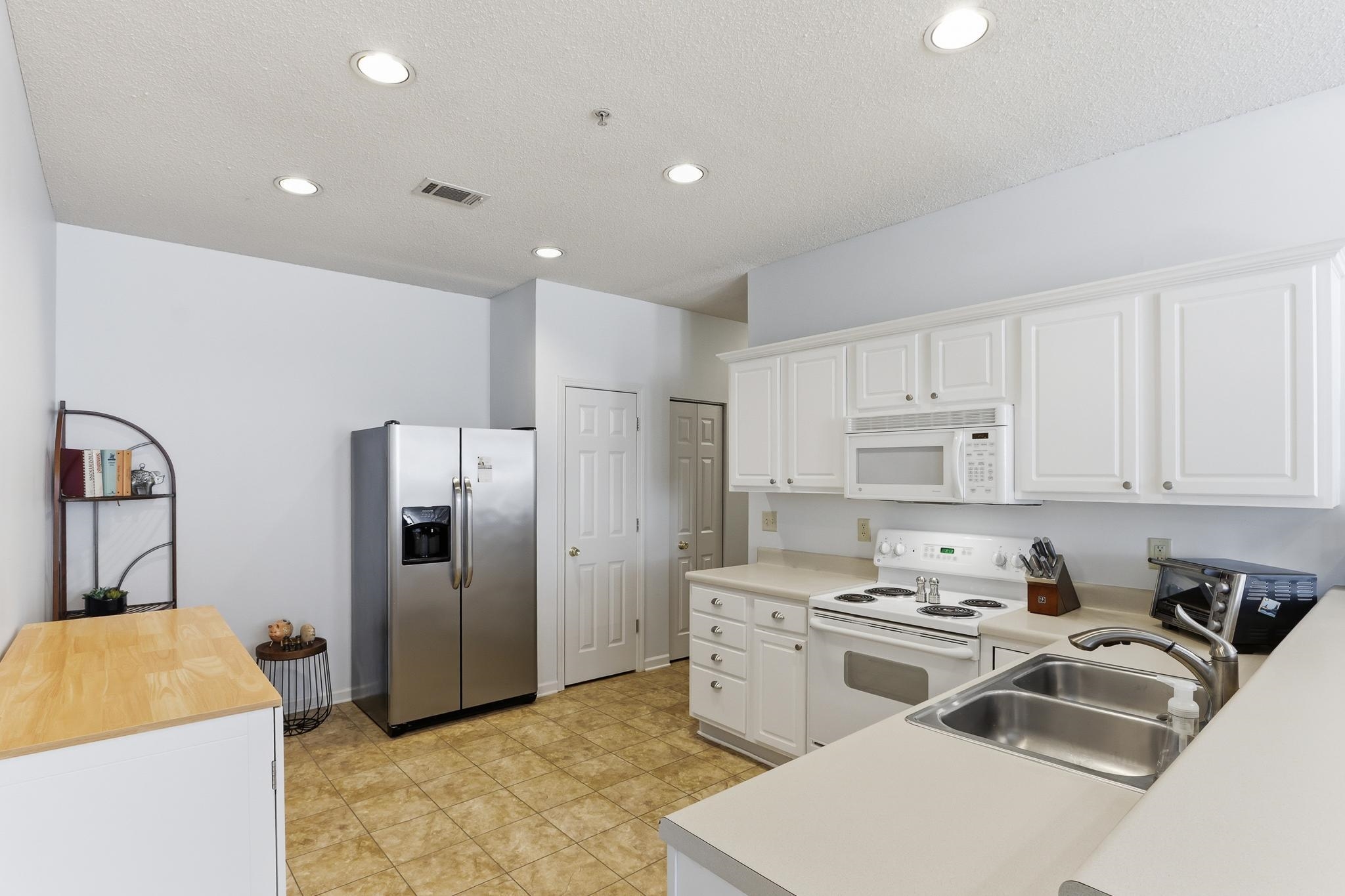 1075 Oak Timber Circle, Unit 69 Collierville, TN 38017 - Photo 20 of 35 a kitchen that has a lot of white cabinets and stainless steel appliances