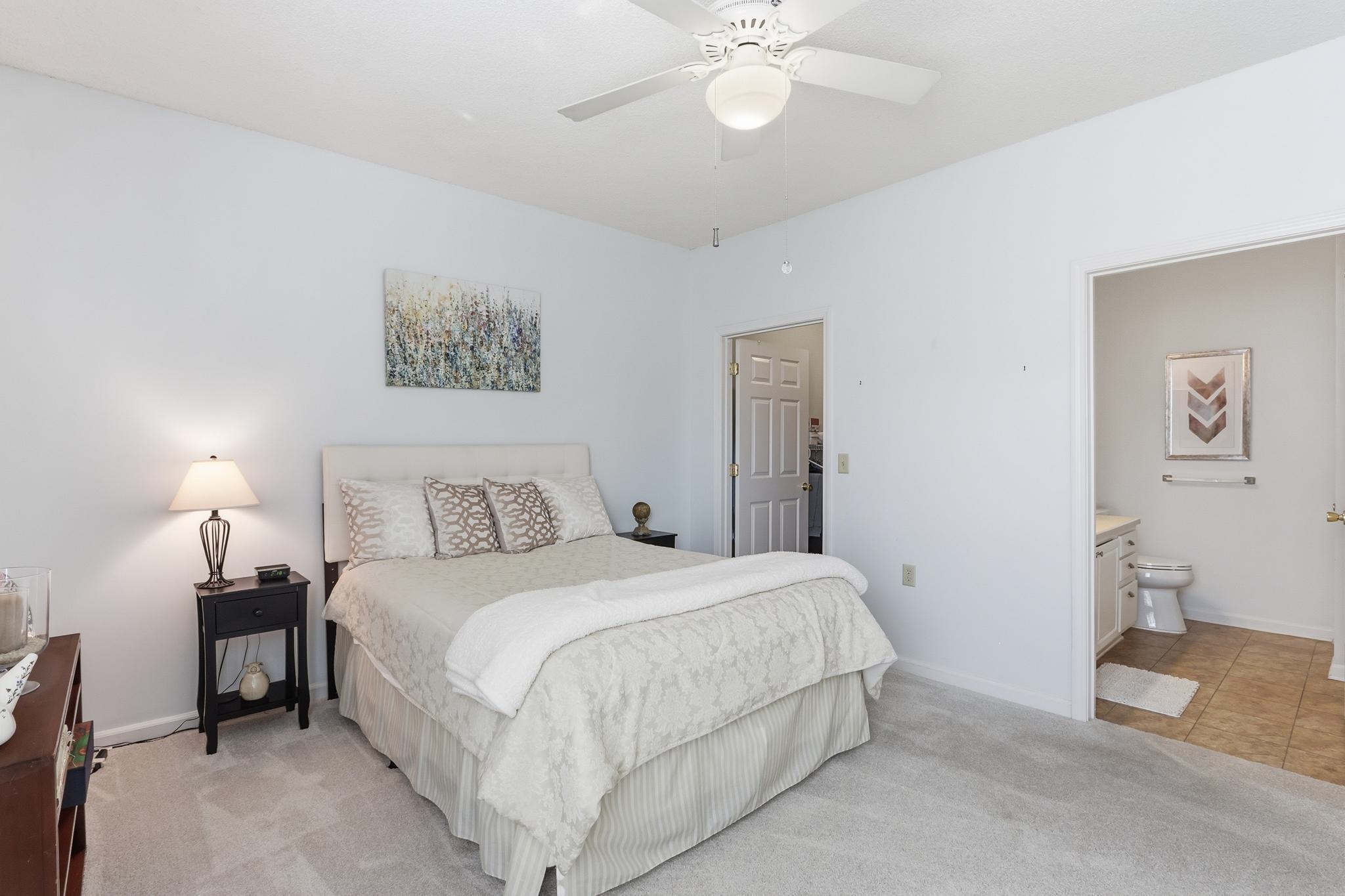 1075 Oak Timber Circle, Unit 69 Collierville, TN 38017 - Photo 26 of 35 a bedroom with a bed and a chandelier