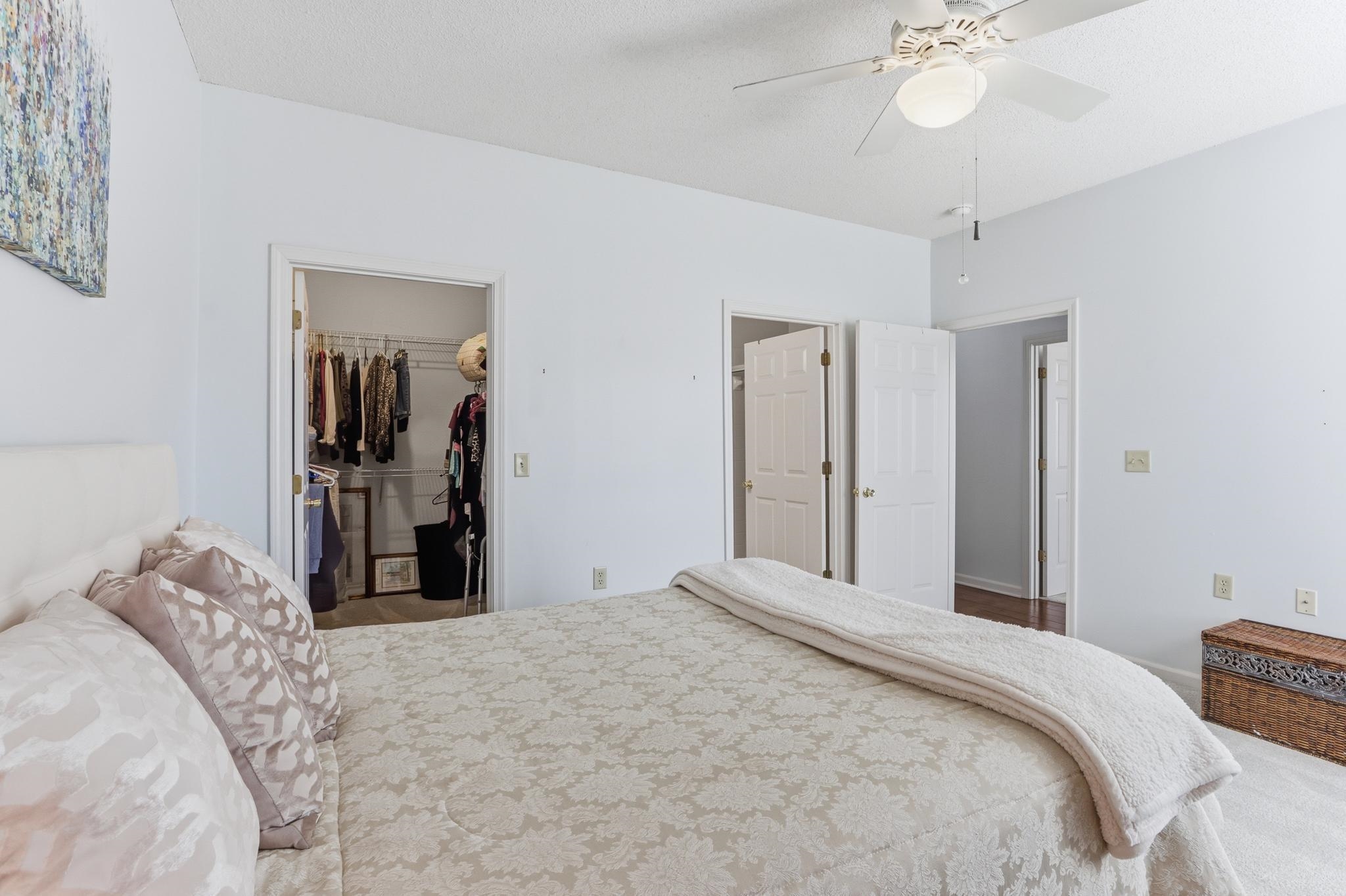 1075 Oak Timber Circle, Unit 69 Collierville, TN 38017 - Photo 27 of 35 a bedroom with a bed and a chandelier
