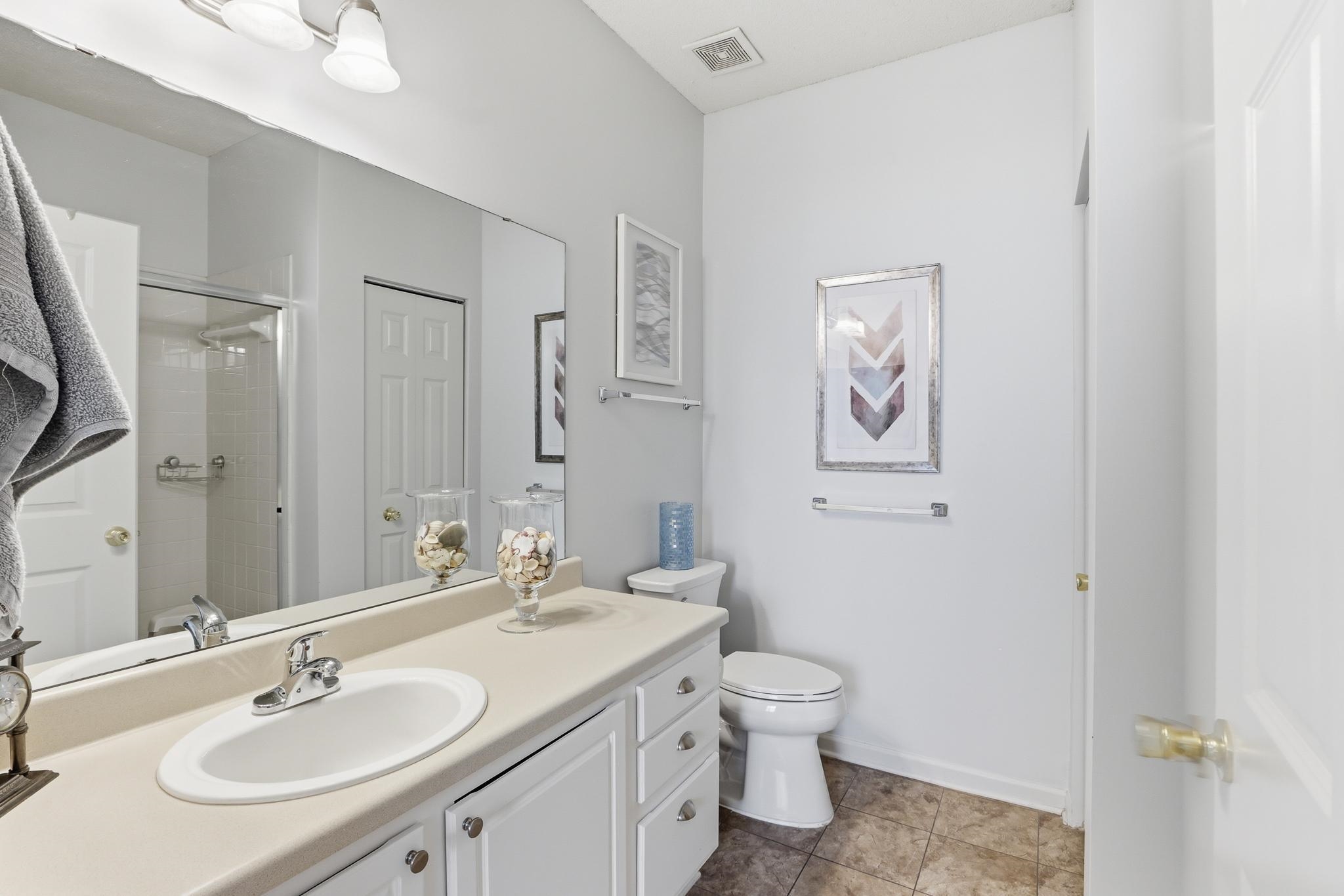 1075 Oak Timber Circle, Unit 69 Collierville, TN 38017 - Photo 28 of 35 a bathroom with a granite countertop sink toilet and shower