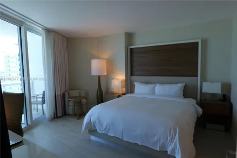 a bedroom with a bed and a night stand