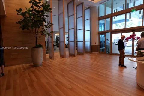 a view of a room with wooden floor and bench