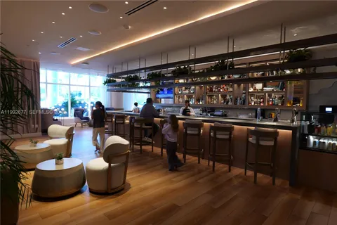 a living room with lots of furniture and kitchen view